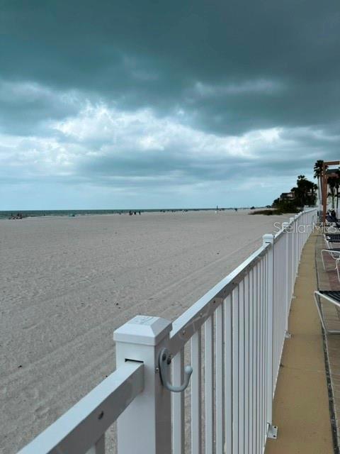 A wide, sandy beach stretches toward the ocean under a cloudy sky — 17920 GULF BOULEVARD UNIT 502, REDINGTON SHORES, FL