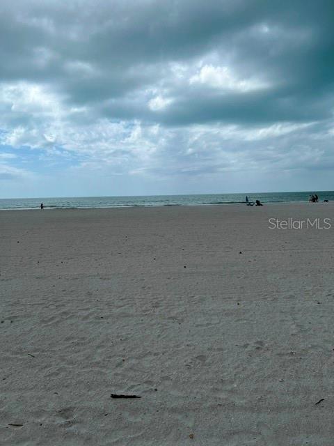 A white fence borders a sandy beach under a cloudy sky — 17920 GULF BOULEVARD UNIT 502, REDINGTON SHORES, FL