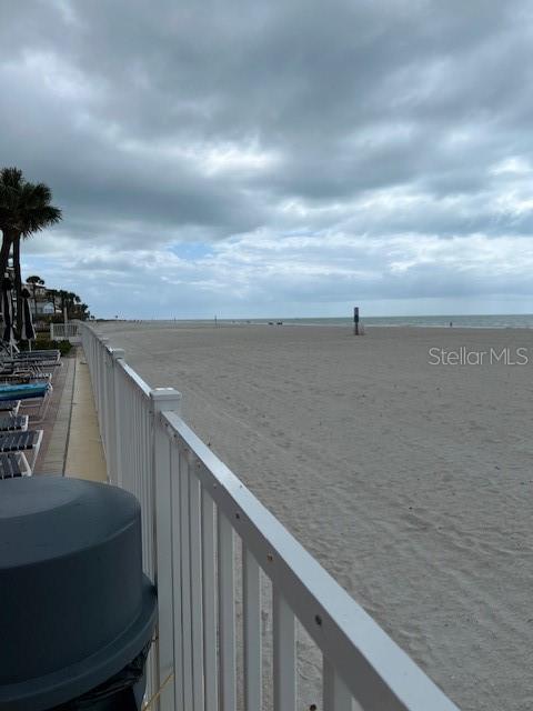A swimming pool overlooks the ocean next to a multi-story building — 17920 GULF BOULEVARD UNIT 502, REDINGTON SHORES, FL