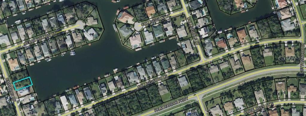 This is an aerial map showing a residential neighborhood with waterfront properties and a highlighted lot — 10 CIMMARON DRIVE, PALM COAST, FL