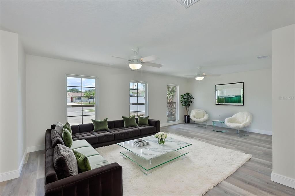 A single-story brick house features a concrete driveway, a two-car garage, and mature trees — 8410 LAVA PLACE, TAMPA, FL