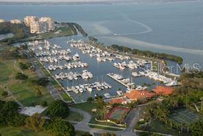 An aerial view of a marina filled with boats next to a residential complex — 2600 HARBOURSIDE DRIVE UNIT Q-10, LONGBOAT KEY, FL