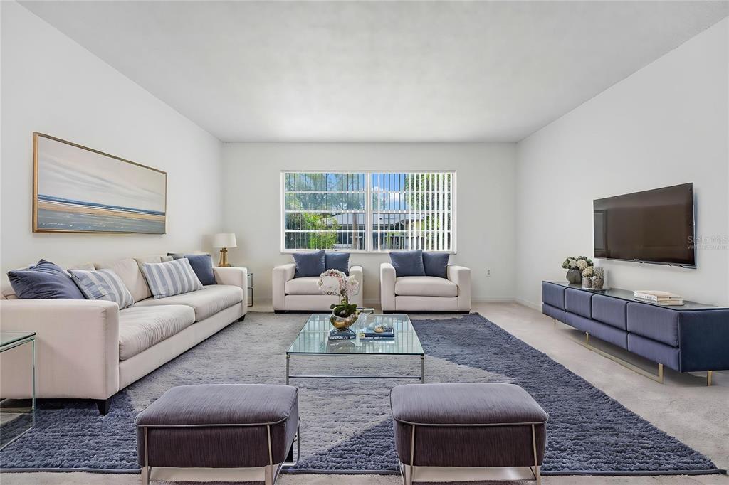 A bedroom features a bed with teal bedding, a wooden dresser, and two framed artworks — 5060 ANDREA BOULEVARD, ORLANDO, FL