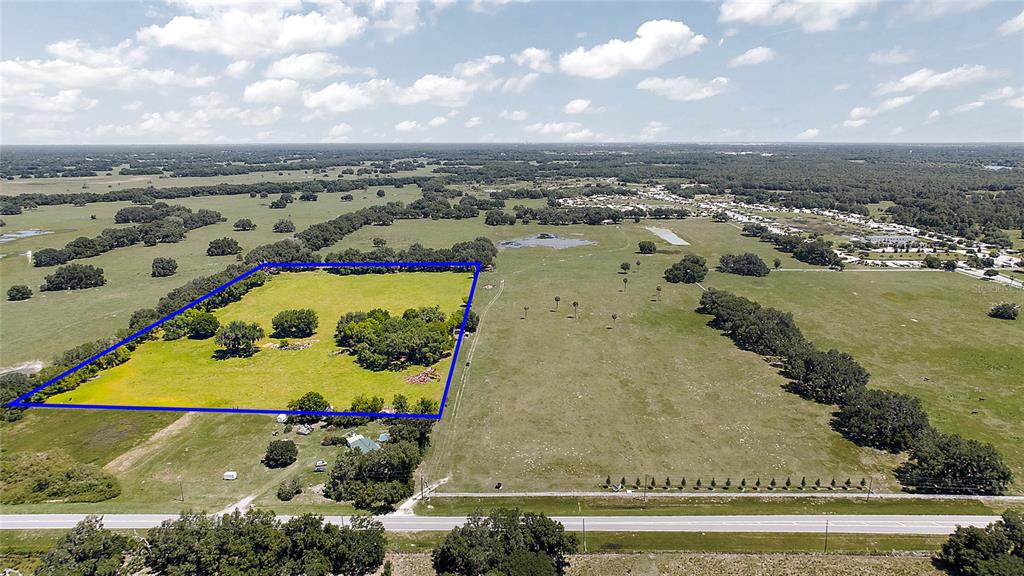 An aerial view shows a large, grassy rural property outlined in blue next to a road — E C-478 -UNASSIGNED ADDRESS, WEBSTER, FL