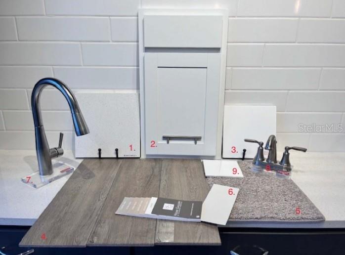 A display of interior design samples including cabinetry, flooring, countertop, and plumbing fixtures — 172 FLAG LILLY LANE, UMATILLA, FL