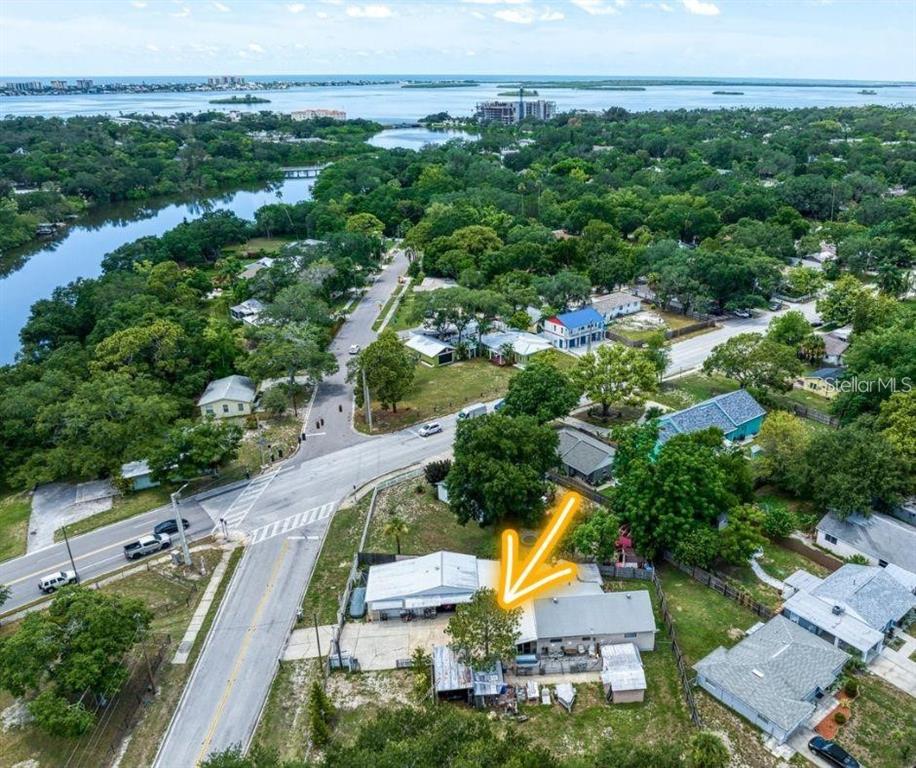 An aerial view shows a single-story house with a white roof near a road — 1769 OVERBROOK AVENUE, CLEARWATER, FL