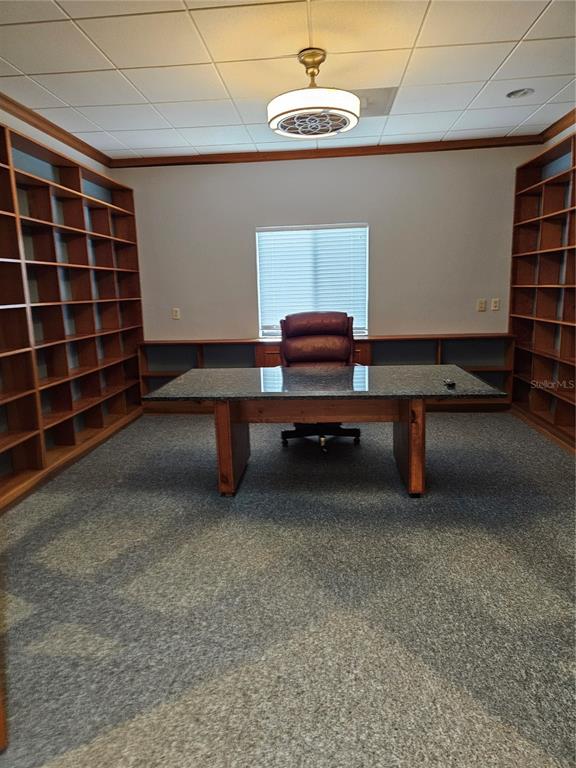 A home office features built-in wooden shelving, a granite-topped desk, and a rolling leather chair — 2389 RINGLING BOULEVARD UNIT A, SARASOTA, FL