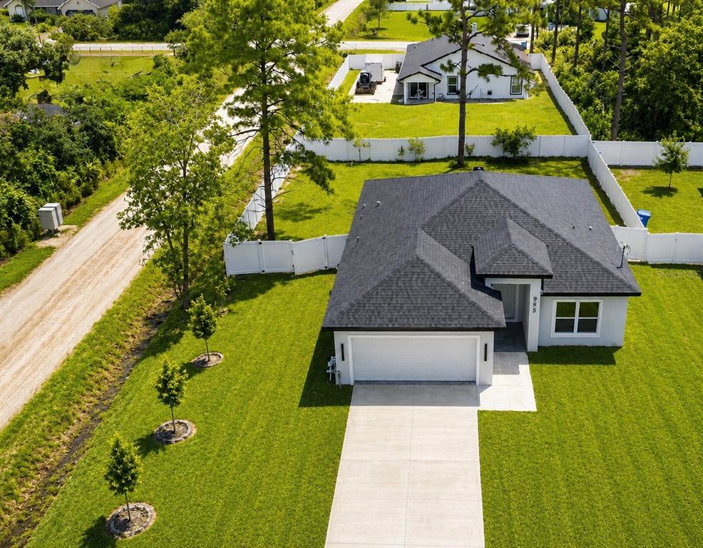 This floor plan shows a three-bedroom, two-bath home with an open kitchen, living, and dining area — 995 9TH AVENUE, DELAND, FL