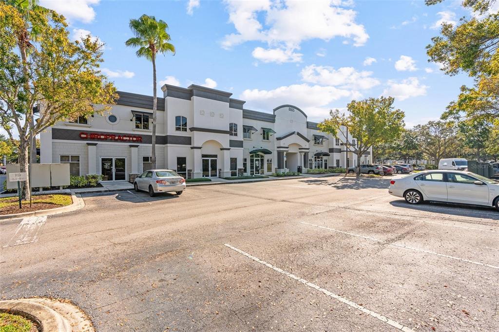 A two-story commercial office building with a parking lot in the foreground — 8865 COMMODITY CIRCLE UNIT 14, ORLANDO, FL