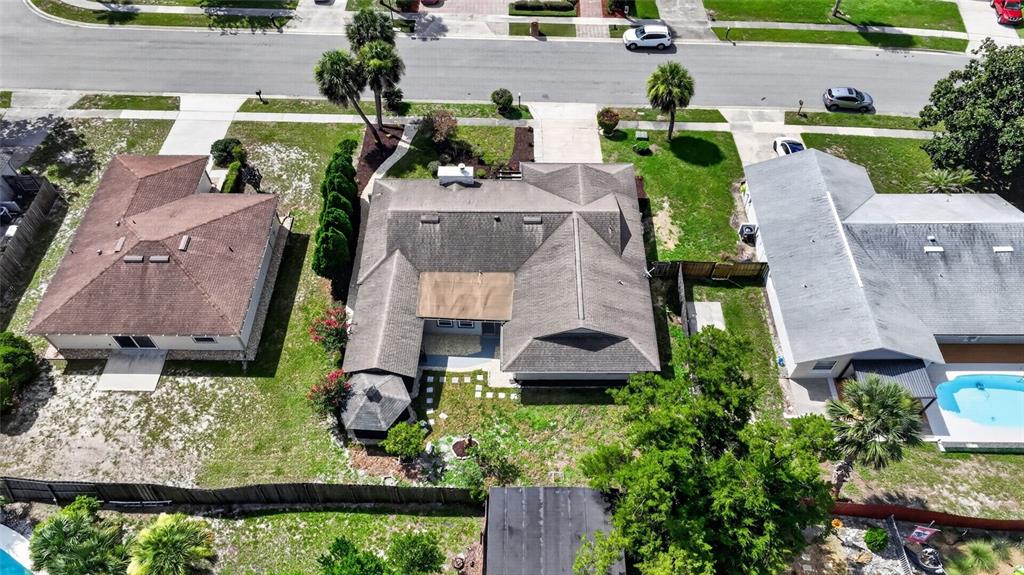 An aerial view shows three suburban houses with shingled roofs and surrounding yards — 3179 FOXWOOD DR, APOPKA, FL