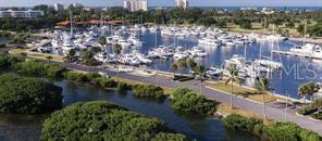 An aerial view of a marina filled with boats next to a road and mangroves — 2800 HARBOURSIDE DRIVE UNIT E-16, LONGBOAT KEY, FL