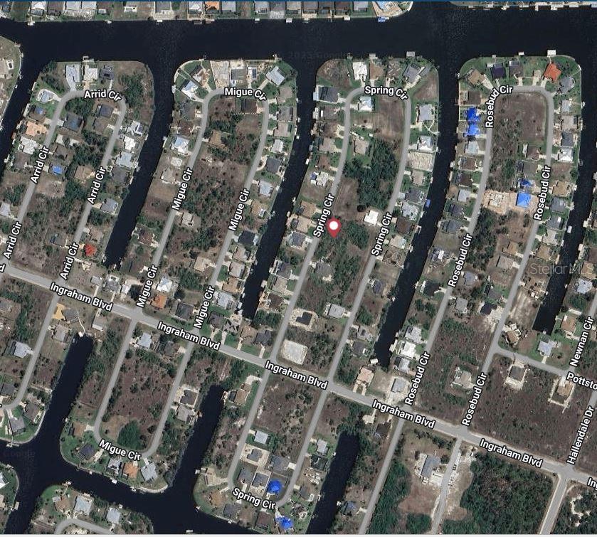 This is an aerial map showing residential streets and vacant lots along canals — 9229 SPRING CIRCLE, PORT CHARLOTTE, FL