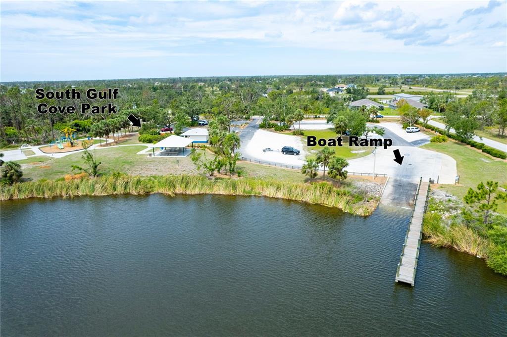 An aerial view shows a park with a playground, picnic pavilion, and a boat ramp — 9229 SPRING CIRCLE, PORT CHARLOTTE, FL