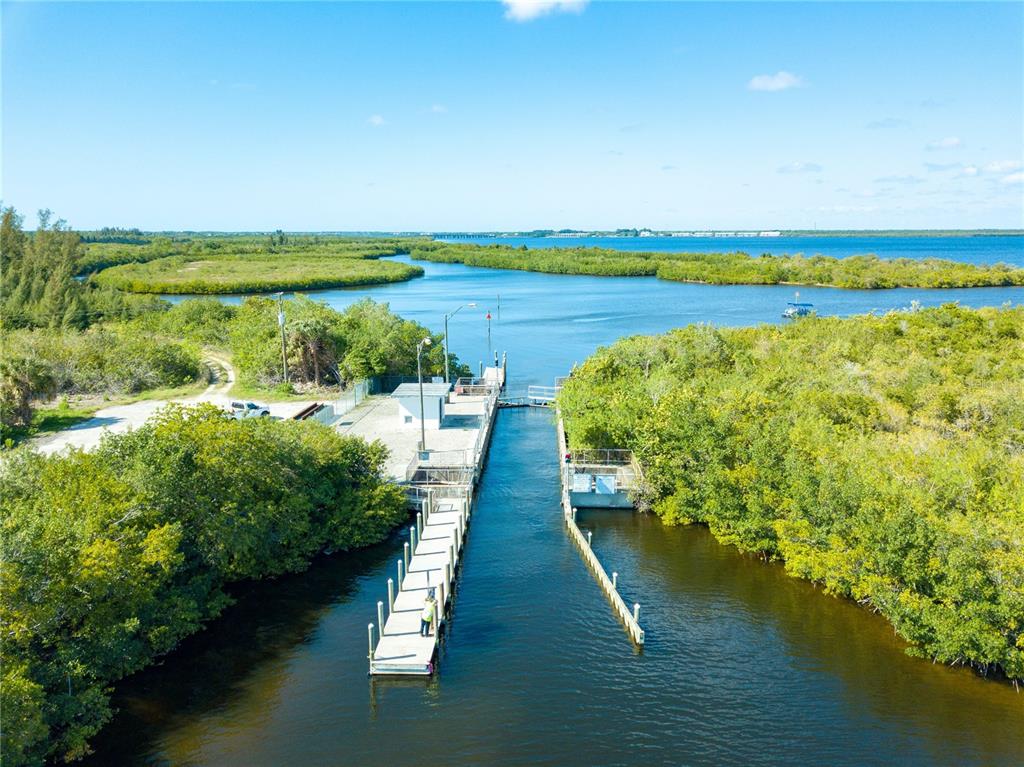 An aerial view shows a boat dock and ramp surrounded by dense green mangroves — 9229 SPRING CIRCLE, PORT CHARLOTTE, FL