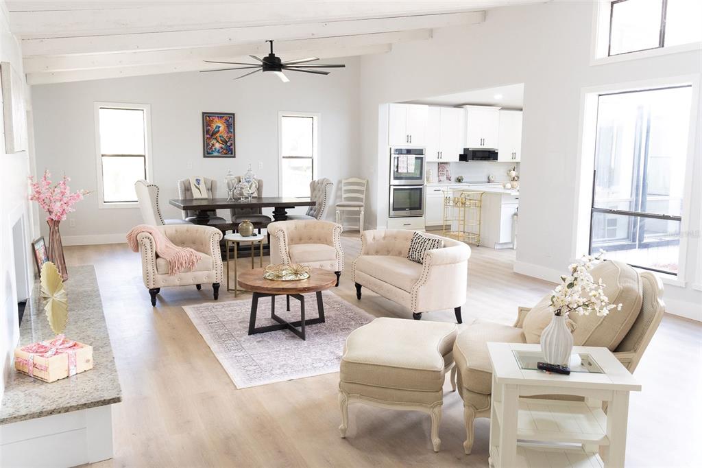 A bright home office features light wood flooring, a modern ceiling fan, and large windows — 4212 HOMEWOOD LANE, LAKELAND, FL