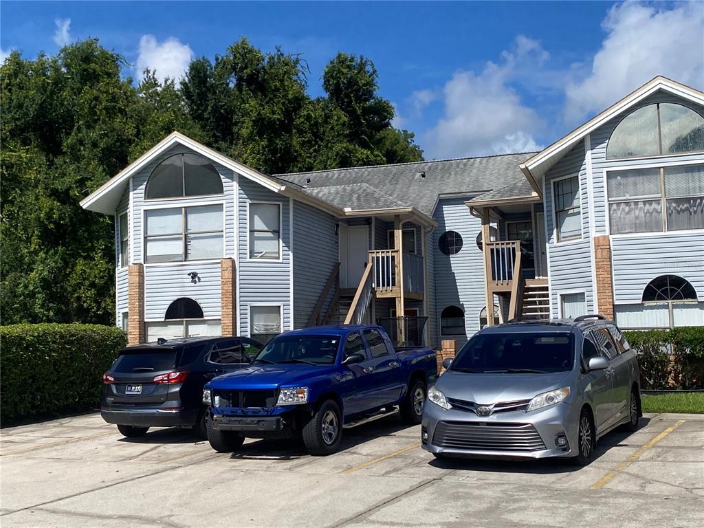 A two-story light blue siding building with a staircase leading to an upper entrance — 2706 RIO GRANDE TRAIL UNIT 2706, KISSIMMEE, FL