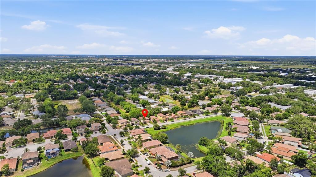 A kitchen features wood cabinets, granite countertops, stainless steel appliances, and a central island — 5666 AARON COURT, SARASOTA, FL