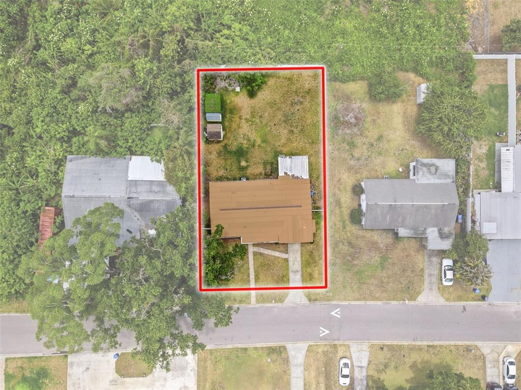 An aerial view shows a single-story house with a brown roof and a screened porch — 2518 W NORTH STREET, TAMPA, FL