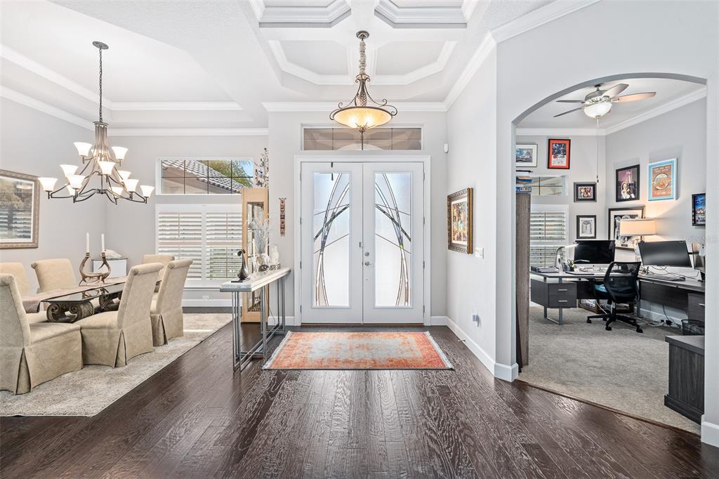A foyer with dark wood floors leads to a dining room and a home office — 630 WOODBRIDGE DRIVE, ORMOND BEACH, FL