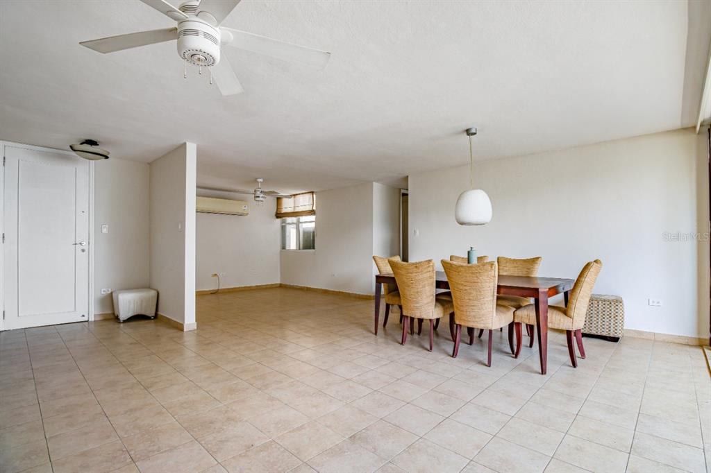 A dining area with a wooden table and six chairs sits on tiled flooring — FULL POWER GENERATOR KINGS COURT 80 STREET UNIT 804, SAN JUAN, PR