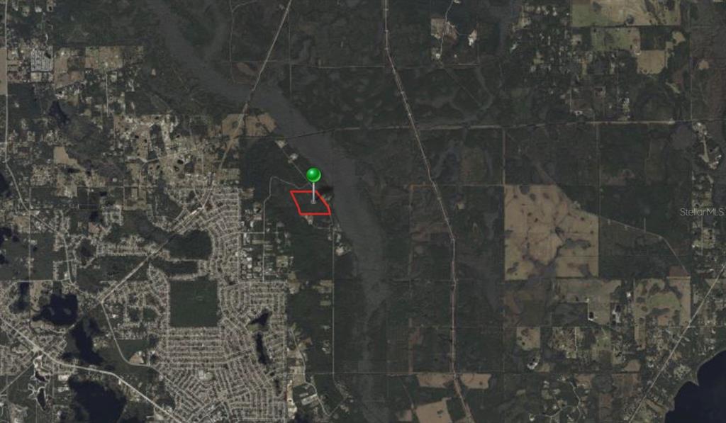 An aerial map view shows a red-outlined property parcel marked with a green location pin — 2370 OLD TRAIN ROAD, DELTONA, FL