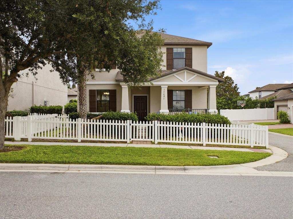 A two-story house with a white picket fence and a front porch — 15401 PORTER ROAD, WINTER GARDEN, FL