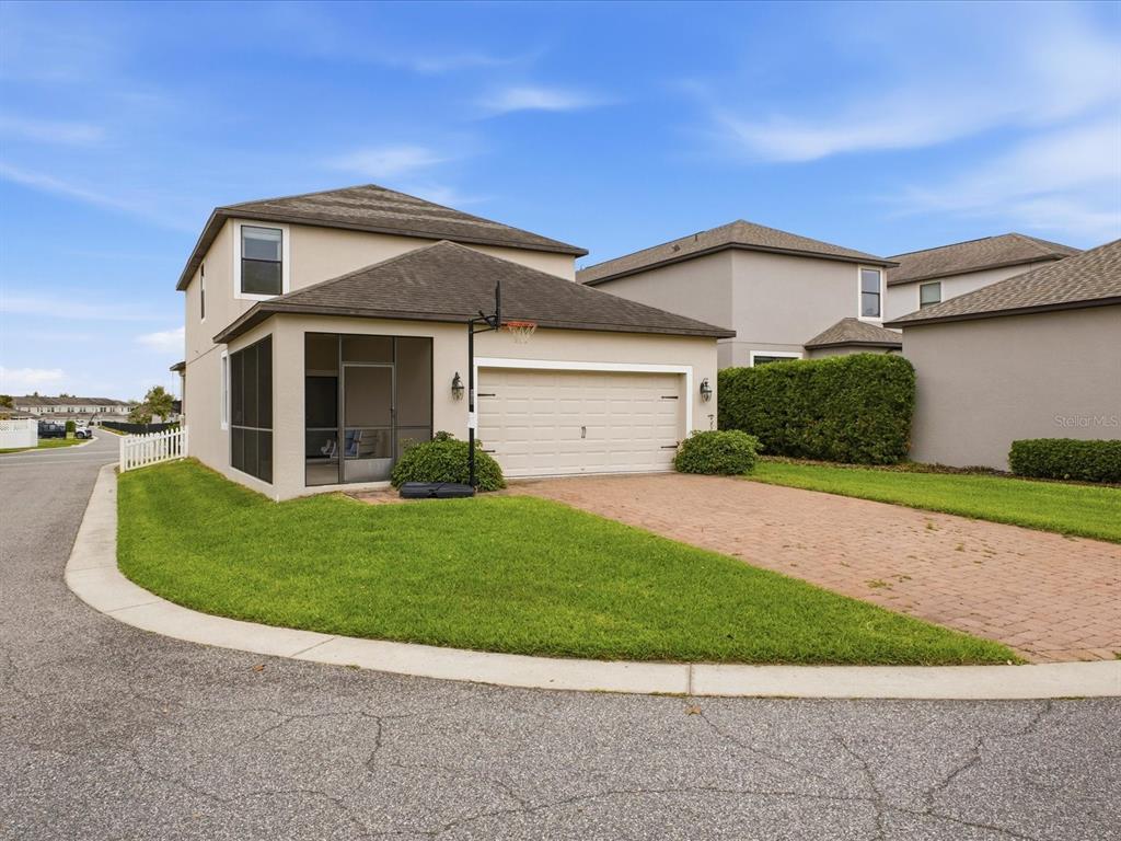 A two-story house with a screened porch, a two-car garage, and a brick paver driveway — 15401 PORTER ROAD, WINTER GARDEN, FL