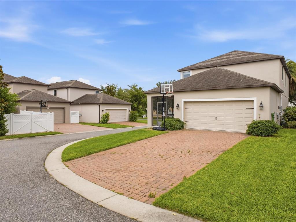 A two-story house with a brick driveway and a basketball hoop in the front yard — 15401 PORTER ROAD, WINTER GARDEN, FL