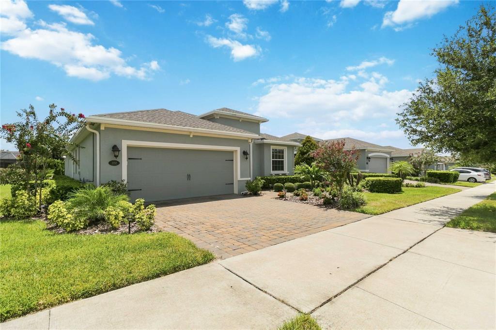 A single-story house with a gray exterior, a two-car garage, and a paved driveway — 1212 VICTORIA HILLS DRIVE N, DELAND, FL