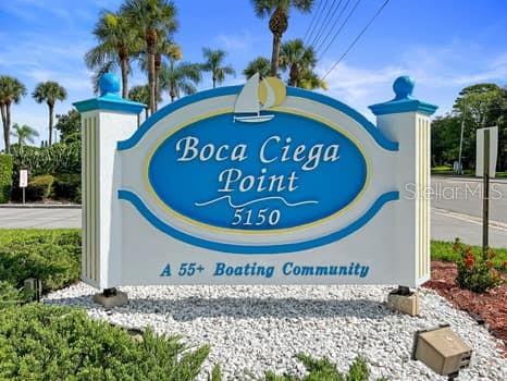 A bathroom features a glass-enclosed shower, a white toilet, and a vanity with a stone countertop — 146 BOCA CIEGA POINT BLVD BOULEVARD S UNIT 146, ST PETERSBURG, FL