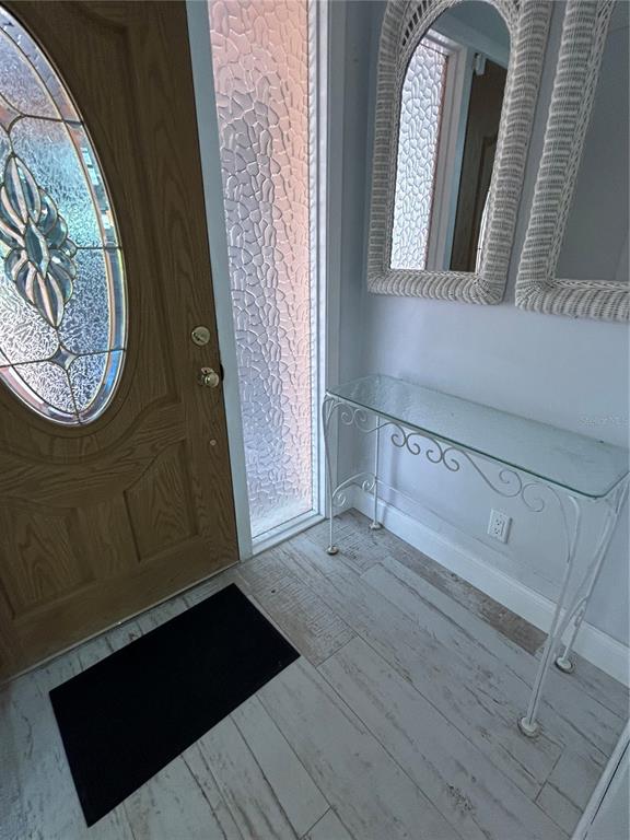 A bathroom features a glass-enclosed shower, a white toilet, and a vanity with a stone countertop — 146 BOCA CIEGA POINT BLVD BOULEVARD S UNIT 146, ST PETERSBURG, FL