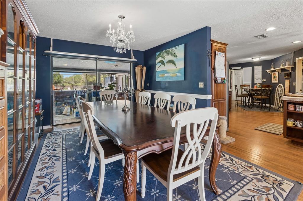 A single-story house with a garage sits behind a lawn with palm trees — 5059 BERNADETTE DRIVE, ZEPHYRHILLS, FL