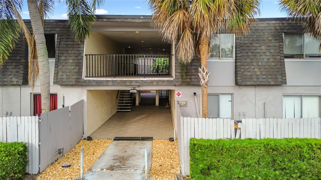 A two-story apartment building features a covered ground-level entryway and an upper-level balcony — 1928 CONWAY RD UNIT 33, ORLANDO, FL