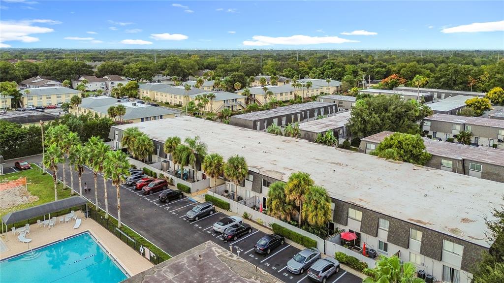 An aerial view shows a multi-story apartment complex with a swimming pool and parking lot — 1928 CONWAY RD UNIT 33, ORLANDO, FL