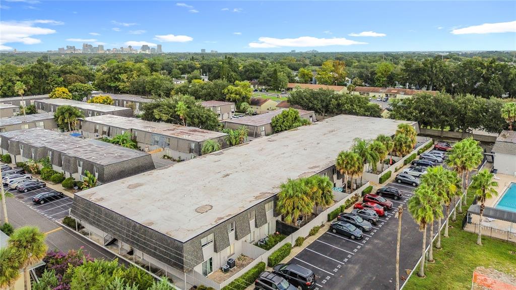 An aerial view shows multi-story apartment buildings with flat roofs and adjacent parking lots — 1928 CONWAY RD UNIT 33, ORLANDO, FL