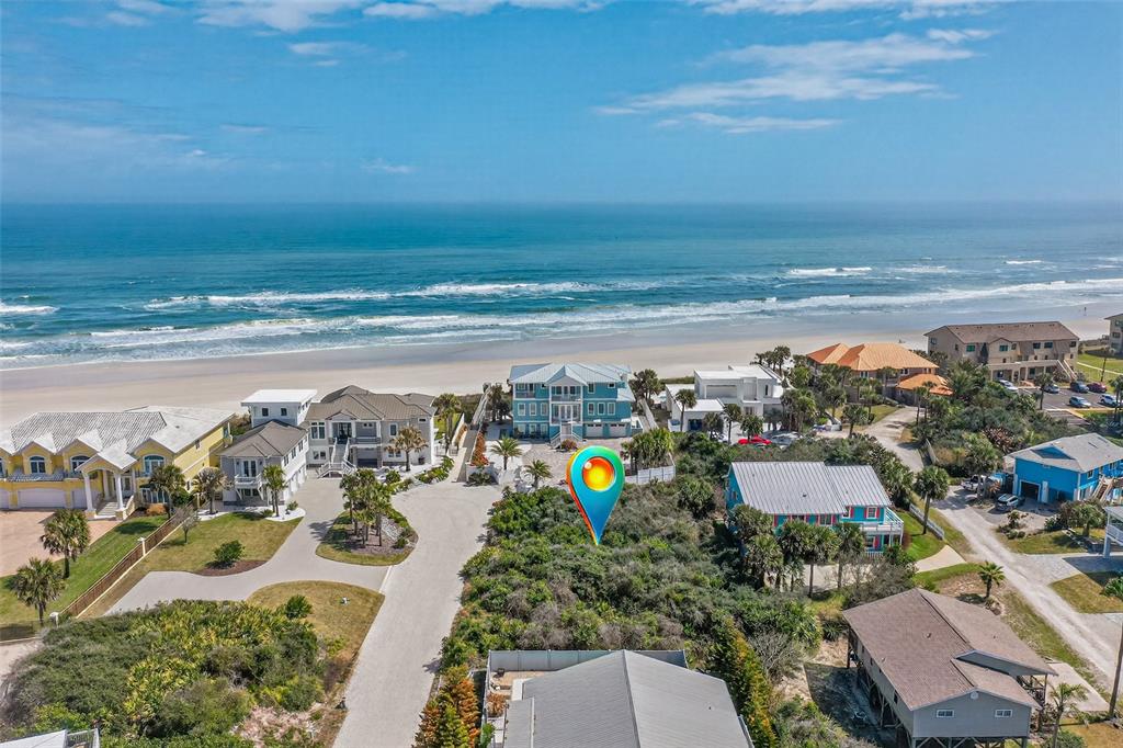 An aerial view shows a vacant, brush-covered lot situated between several beach houses — 21 JESSICA LYNN PLACE, ST AUGUSTINE, FL