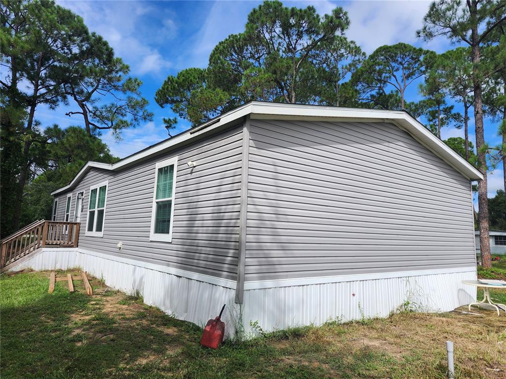 An aerial view shows a single-story house with a gray roof surrounded by trees — 4550 POLK CITY ROAD, HAINES CITY, FL