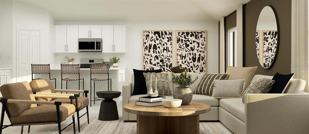 A kitchen with sage green cabinets, a wooden dining table, and black chairs — 3619 ROLLING RIDGE BEND, DAVENPORT, FL
