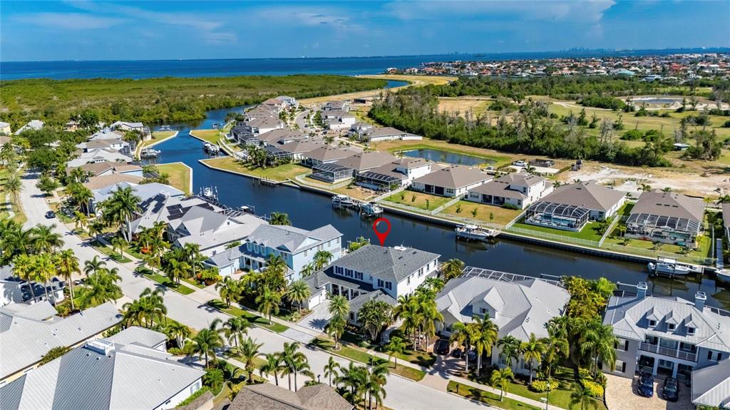 An aerial view of a waterfront residential neighborhood with a marked house and canal — 713 ISLEBAY DRIVE, APOLLO BEACH, FL