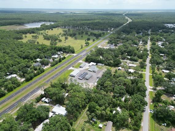 An aerial view shows a commercial property with several buildings situated between two roads — 25164 E COLONIAL DRIVE, CHRISTMAS, FL