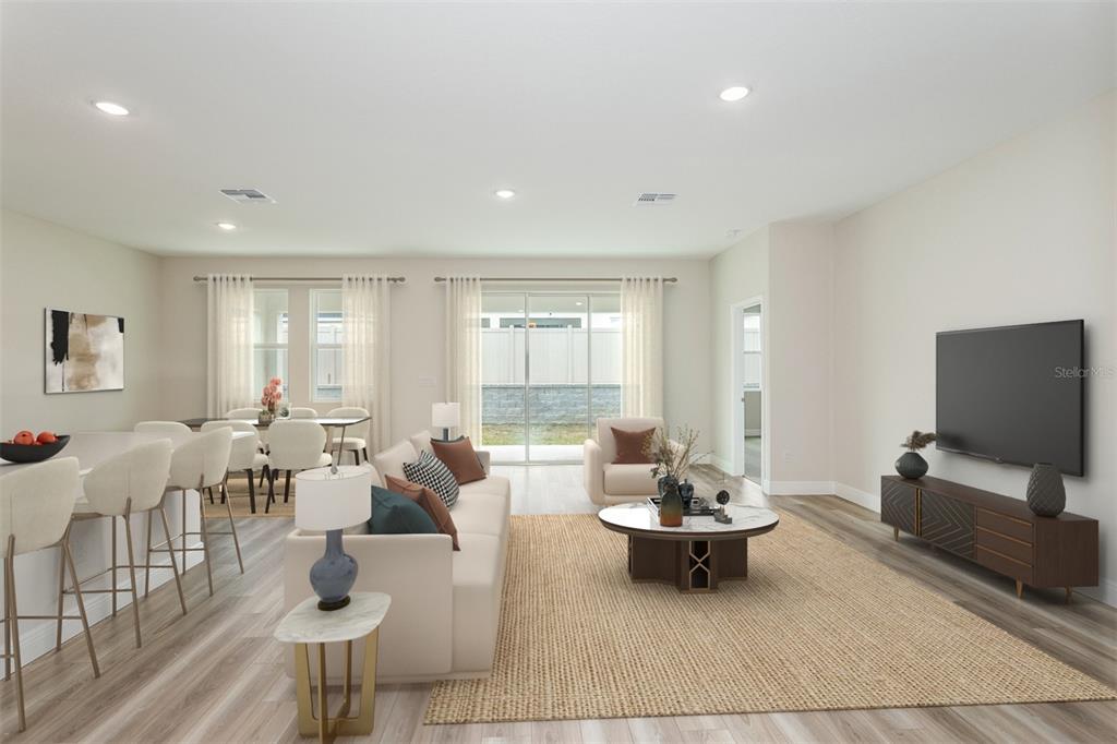 This is a digital rendering of an open-concept living and dining area with neutral finishes — 33531 HAMMOCK BEACH WAY, DADE CITY, FL