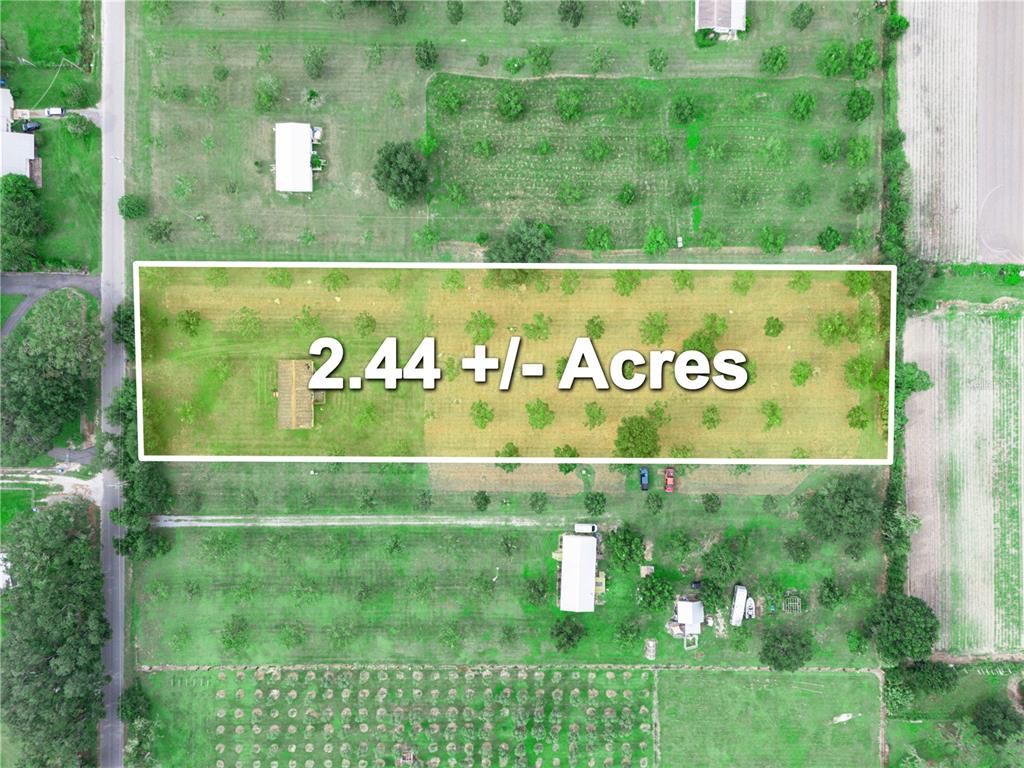 An aerial view shows a rectangular plot of land with trees and a small building — 8564 CAREY ROAD, LITHIA, FL