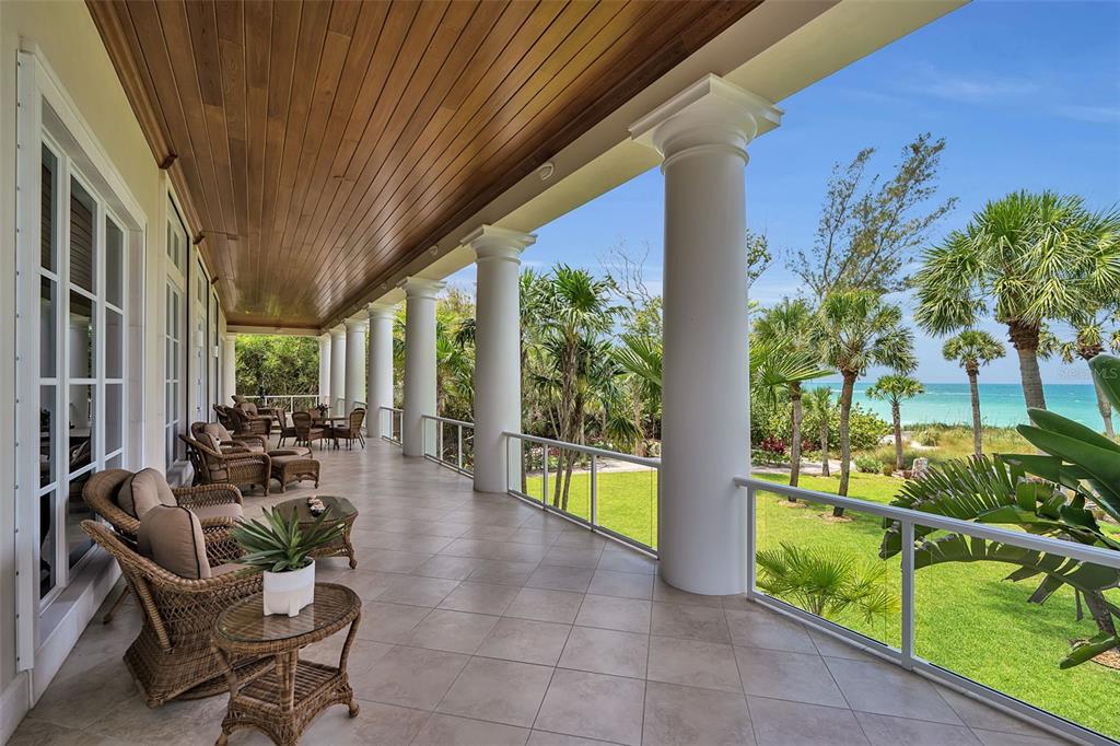 An aerial view shows luxury homes situated on a narrow strip between the ocean and bay — 8132 SANDERLING ROAD, SARASOTA, FL