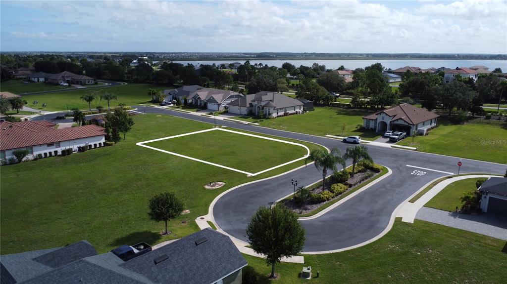 An aerial view shows a vacant residential lot outlined in white within a suburban neighborhood — 587 LOBLOLLY PLACE, AUBURNDALE, FL