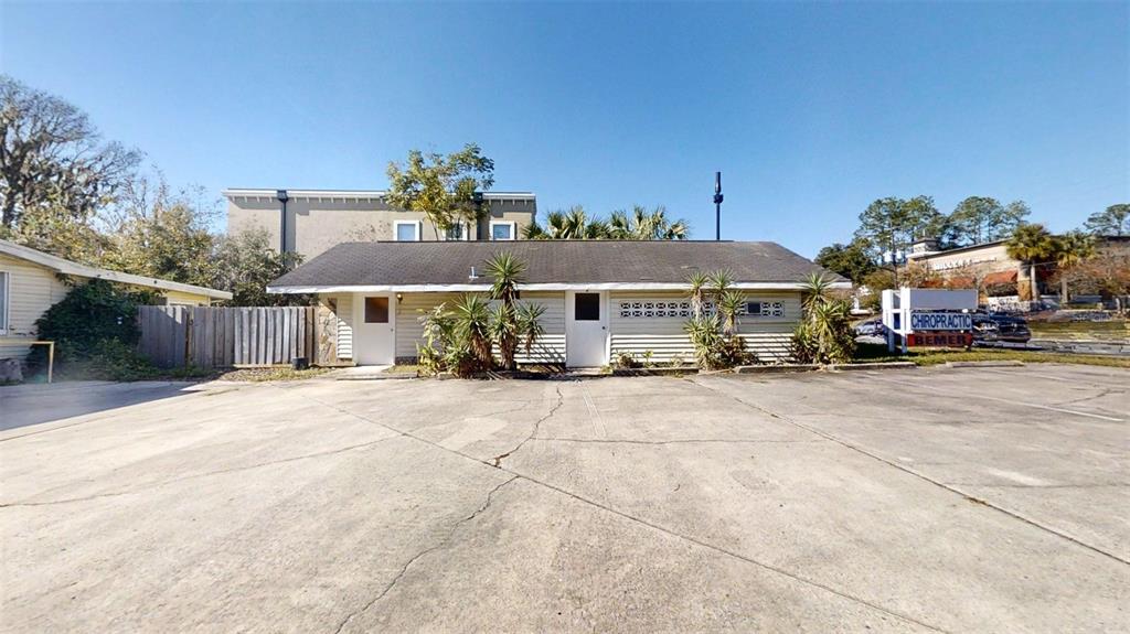 A single-story commercial building with a concrete parking lot and a chiropractic sign — 420 SE 17TH STREET, OCALA, FL