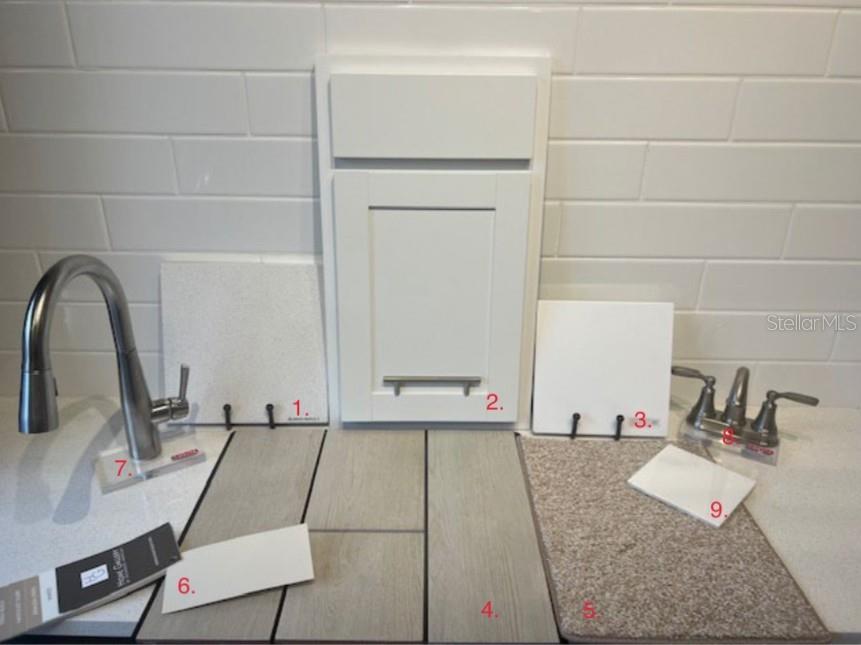 A display of interior design samples including cabinet, flooring, countertop, and plumbing fixture options — 5314 SPRING MAIDEN CIRCLE, APOLLO BEACH, FL