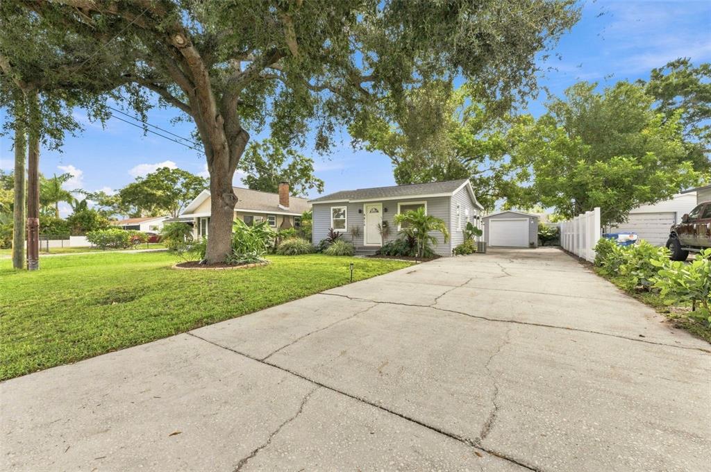 A gray single-story house with a long concrete driveway and a detached garage — 4819 20TH STREET N, ST PETERSBURG, FL