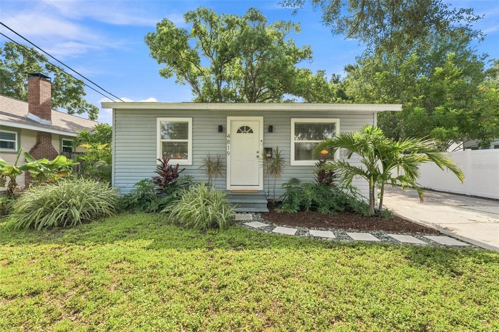 A single-story house with light gray siding, a white front door, and a stone walkway — 4819 20TH STREET N, ST PETERSBURG, FL
