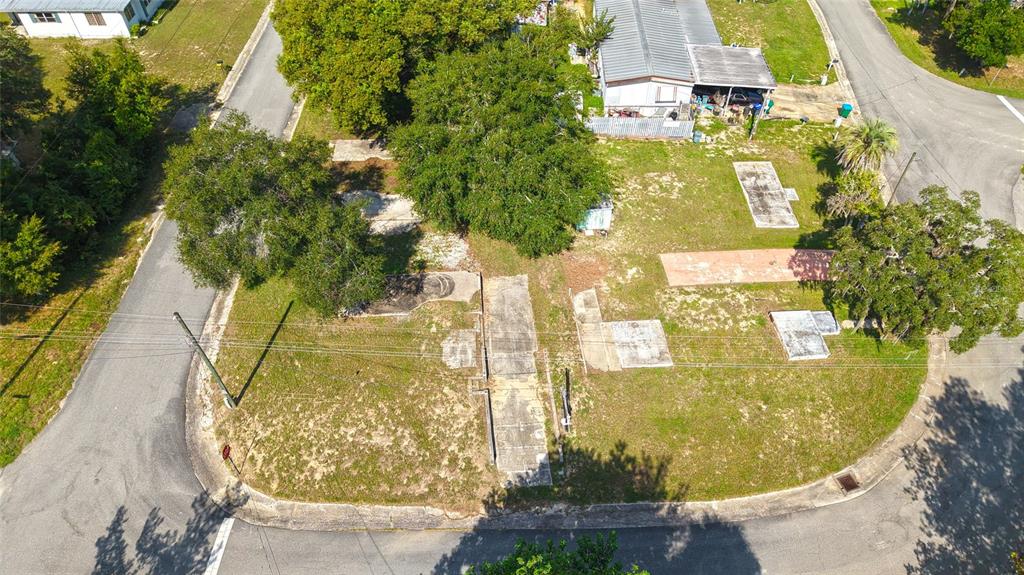An aerial view shows a vacant lot with multiple concrete pads and a nearby mobile home — 3540 E BUFFALO LANE, HERNANDO, FL