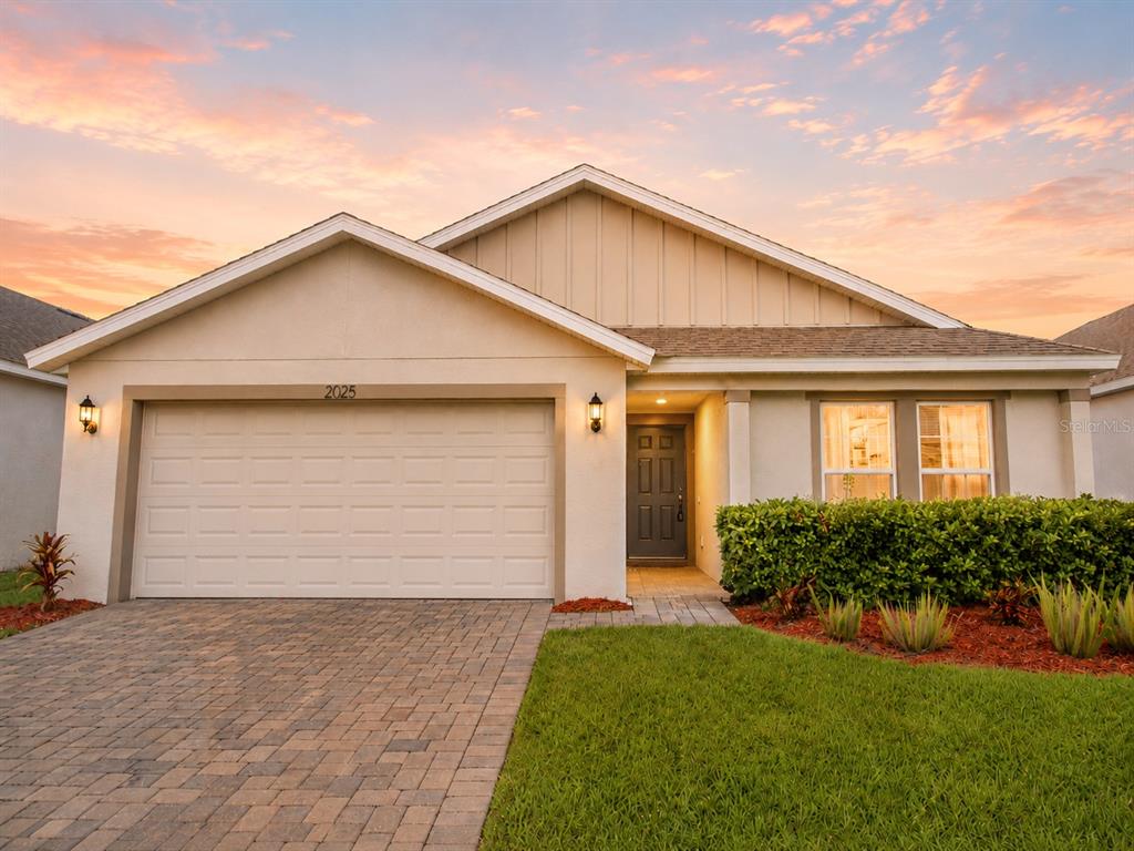 A single-story suburban house with a two-car garage, paved driveway, and a landscaped front yard — 2025 HAVASU FALLS AVENUE, DELAND, FL